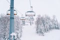 Quadruple chairlift on the slope of a snow-capped mountain Royalty Free Stock Photo