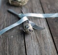 Quail egg in a spoon on a wooden table