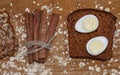 Quail eggs on a black bread and oat chips and cookie and a cinnamon stick Royalty Free Stock Photo