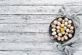 Quail eggs in a black plate. On the old background. Royalty Free Stock Photo