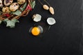 Quail eggs on black stone background, broken, cracked quail egg, yolk of quail egg. Royalty Free Stock Photo