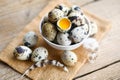 quail eggs on bowl, fresh quail eggs on wooden table background, raw eggs with peel egg shel Royalty Free Stock Photo