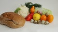 Quail eggs, bread and various fresh vegetables yellow tomatoes, peppers, cauliflower, dill, garlic on a white background Royalty Free Stock Photo