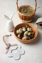 Quail eggs, decorative Easter bunny and basket Royalty Free Stock Photo