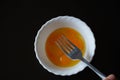 Quail eggs. quail egg yolks in a small white bowl. photo with black background. Royalty Free Stock Photo