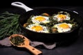 quail eggs fried with asparagus in a nonstick frying pan