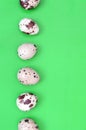 Quail eggs on a light green surface, top view, empty place for t