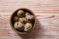 Quail eggs in a little bowl with nest shape