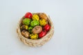 Quail eggs painted in different colors in a light wicker basket