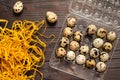 Quail eggs in a plastic container on a dark wooden background. Royalty Free Stock Photo