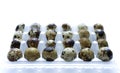 Quail eggs in pack, isolated on white Royalty Free Stock Photo