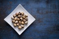 Quail eggs on a plate at blue rustic metal bckground