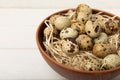 Quail eggs in a plate on an old white wooden background Royalty Free Stock Photo