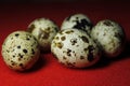 Quail eggs on red background