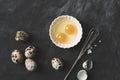 Quail eggs with a whisk on black rustic background Royalty Free Stock Photo