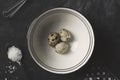 Quail eggs with a whisk on black rustic background Royalty Free Stock Photo