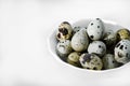 Quail eggs in a white plate. Food eggs on a white background Royalty Free Stock Photo