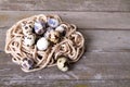 Quail eggs wood background rope