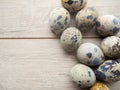 quail eggs in wooden plate over dark old wooden background Royalty Free Stock Photo