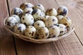 Quail eggs on a wooden table . Healthy food.