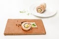 Quail galantine, de-boned stuffed meat as a cold appetizer for a festive dinner, served on a brick stone, white table with copy