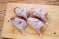 Quails on a cutting board. Thawed poultry preparing for cooking