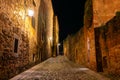 Quaint alley at night with medieval stone buildings, Caceres, Spain. Royalty Free Stock Photo