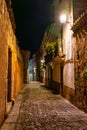 Quaint alley at night with medieval stone buildings, Caceres, Spain. Royalty Free Stock Photo