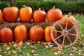 Quaint country setup of harvest pumpkins and a wagon wheel