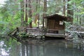 Quaint fishing shack on river.