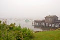 Quaint fishing wharf in fog