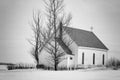 Quaint little white country church sitting on a blanket of snow. Royalty Free Stock Photo