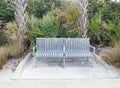 Quaint metal bench along a sidewalk Royalty Free Stock Photo