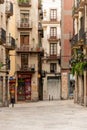 A quaint street in the Gothic Quarter of Barcelona, Spain, features traditional architecture and charming outdoor cafes