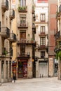 A quaint street in the Gothic Quarter of Barcelona, Spain, features traditional architecture and charming outdoor cafes