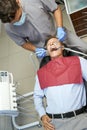 Qualified dentist monitoring teeth of his male patient