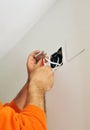 A qualified electrician doing the wiring connections to the television antenna in the junction box for the renovation of the house Royalty Free Stock Photo