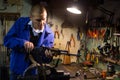 Gunsmith performing maintenance of Kalashnikov assault rifle in workshop