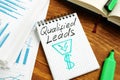 Qualified leads handwritten on a page and business papers