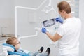 Qualified precise dentist holding up a jaw scan
