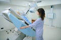 Qualified radiographer is preparing woman for radiological examination