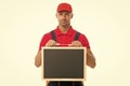 qualified repairman offers his services. male worker in cap hold blackboard. board for copy space. builder service