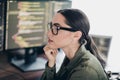Qualified specialist programmer working on coding tasks using multiple monitors in a modern office setting Royalty Free Stock Photo