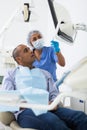 Woman stomatologist explaining treatment to patient in dental office