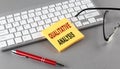 QUALITATIVE ANALYSIS text on a sticky with keyboard, pen glasses on grey background Royalty Free Stock Photo