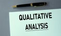 QUALITATIVE ANALYSIS - words on a piece of paper with a pen on a gray background Royalty Free Stock Photo