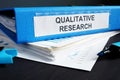 Qualitative research methods report in a folder. Royalty Free Stock Photo