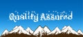 QUALITY ASSURED written with snowflakes on blue sky and snowy mountains background.