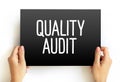 Quality Audit - systematic examination of an organization`s quality management system, text concept on card