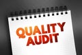 Quality Audit - systematic examination of an organization\'s quality management system, text concept on notepad